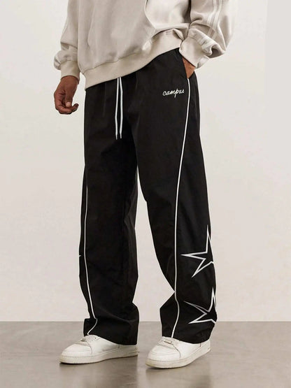 Black quick-dry trousers with white side stripe, star print, elastic drawstring waist.