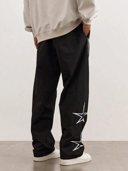 Black quick-dry trousers with white stripe and star graphics along the leg.
