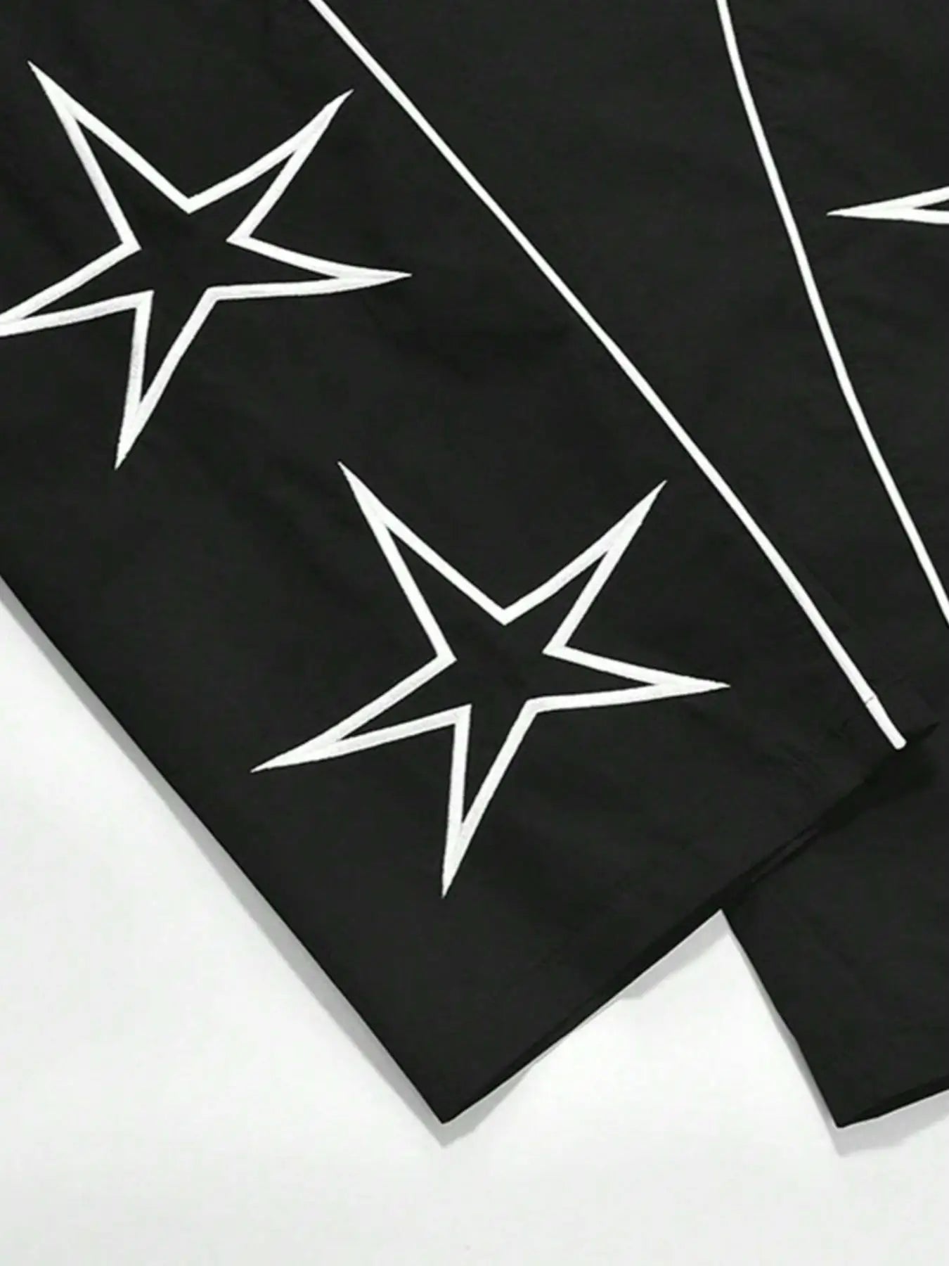 Black quick-dry trousers fabric with white star motifs and thin stripe lines.
