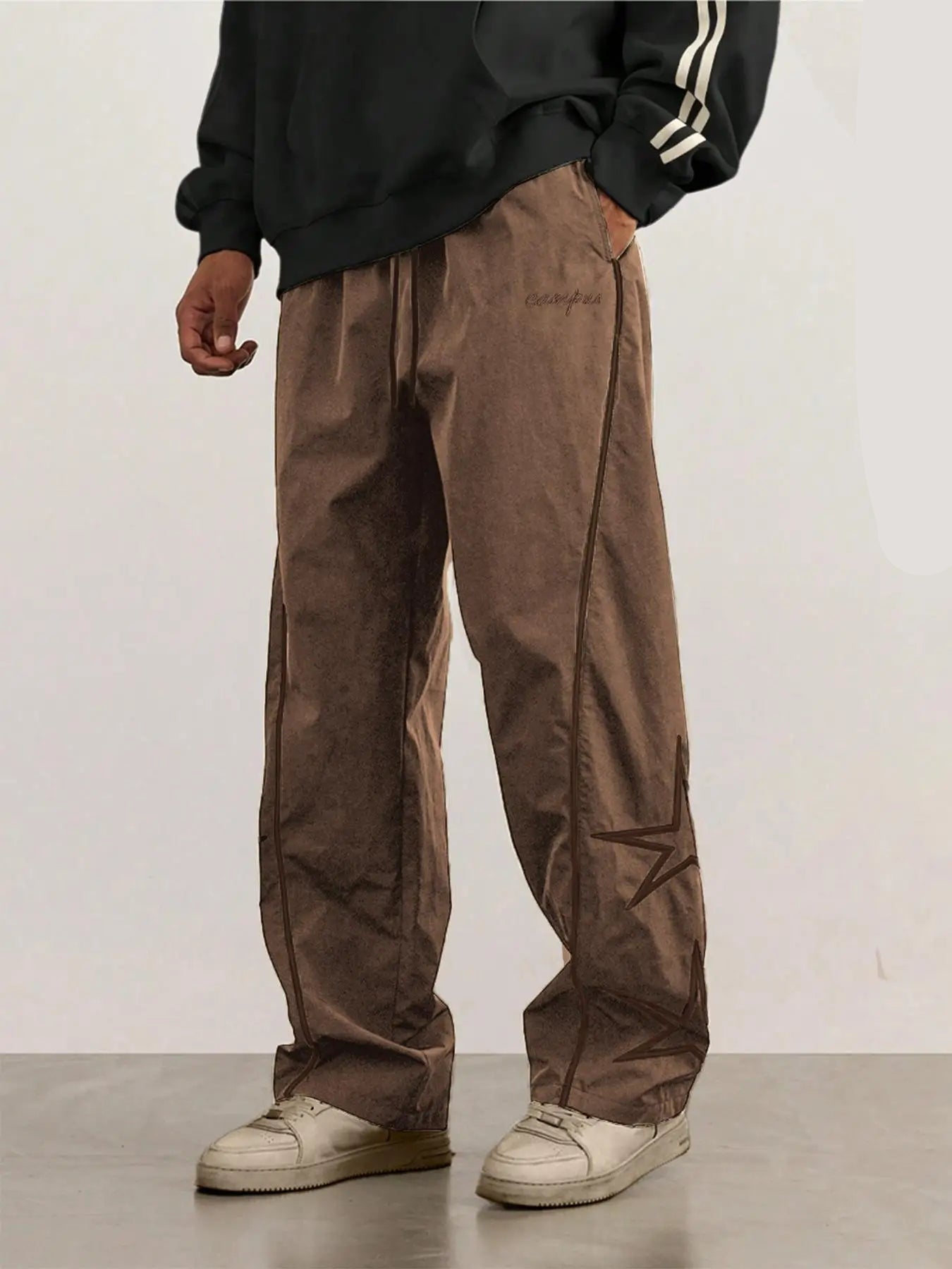 Khaki quick-dry trousers with white side stripe and star graphic, relaxed straight legs.
