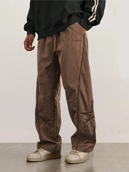 Khaki quick-dry trousers with white side stripe and star graphic, relaxed straight legs.