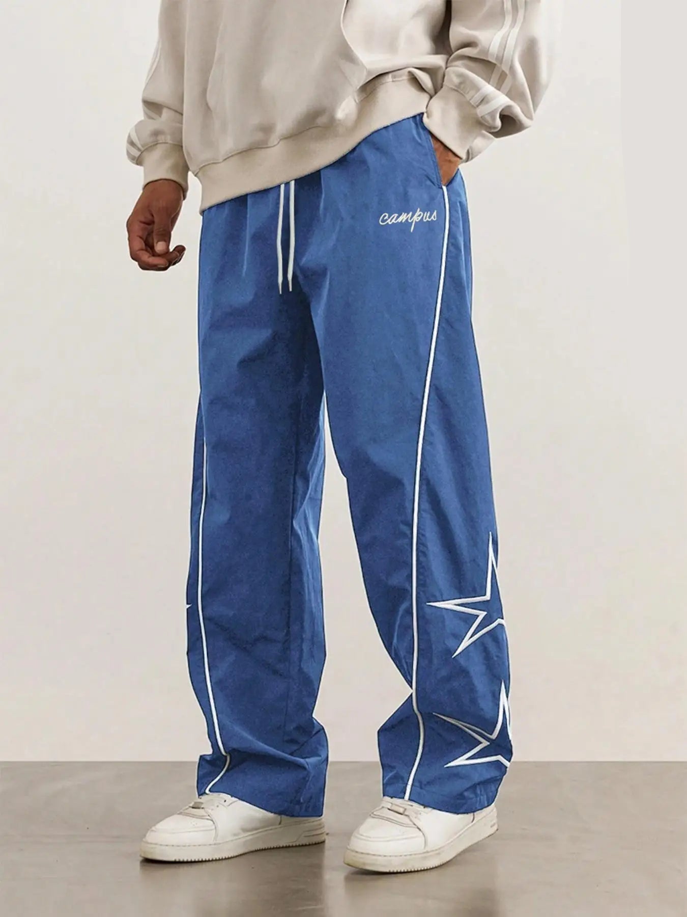 Blue quick-dry trousers with white side stripe, star print, elastic drawstring waist.