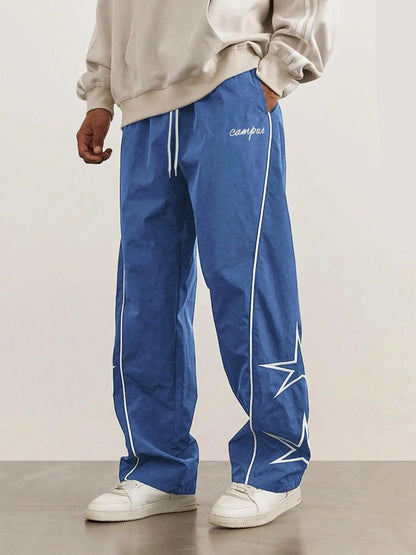 Blue quick-dry trousers with white side stripe, star print, elastic drawstring waist.