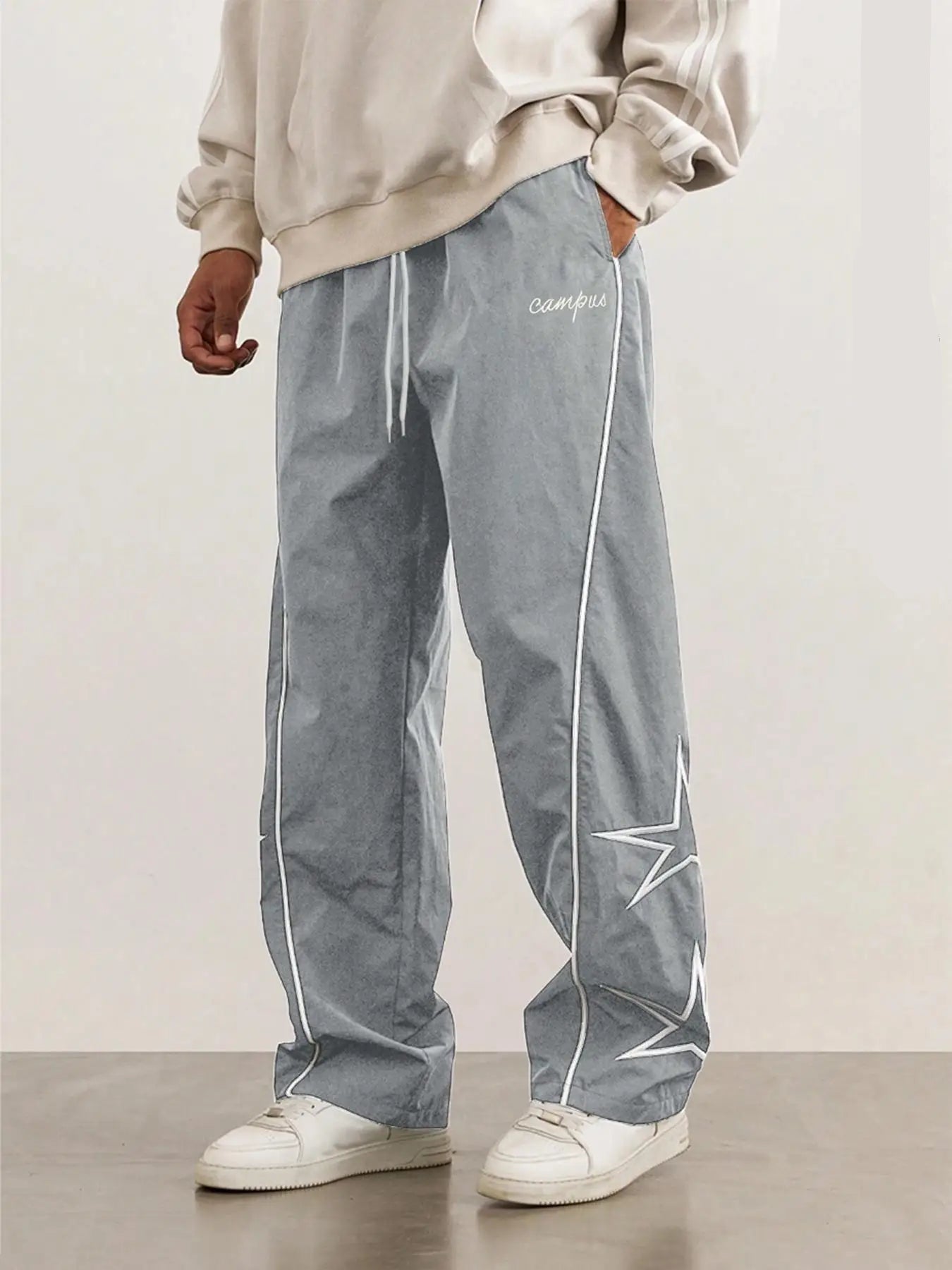 Gray quick-dry trousers with white side stripe and star graphic on one leg.