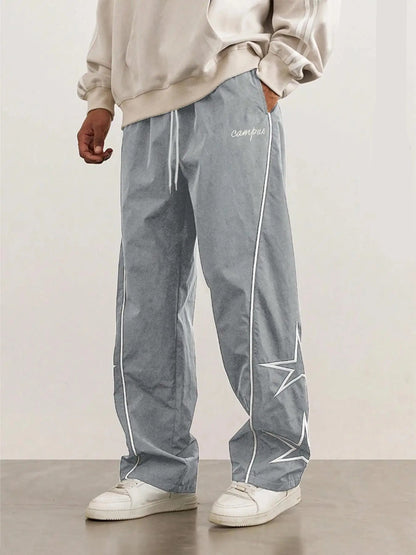 Gray quick-dry trousers with white side stripe and star graphic on one leg.