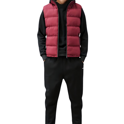 Men’s quilted puffer vest in red with front zipper, worn over a dark hoodie