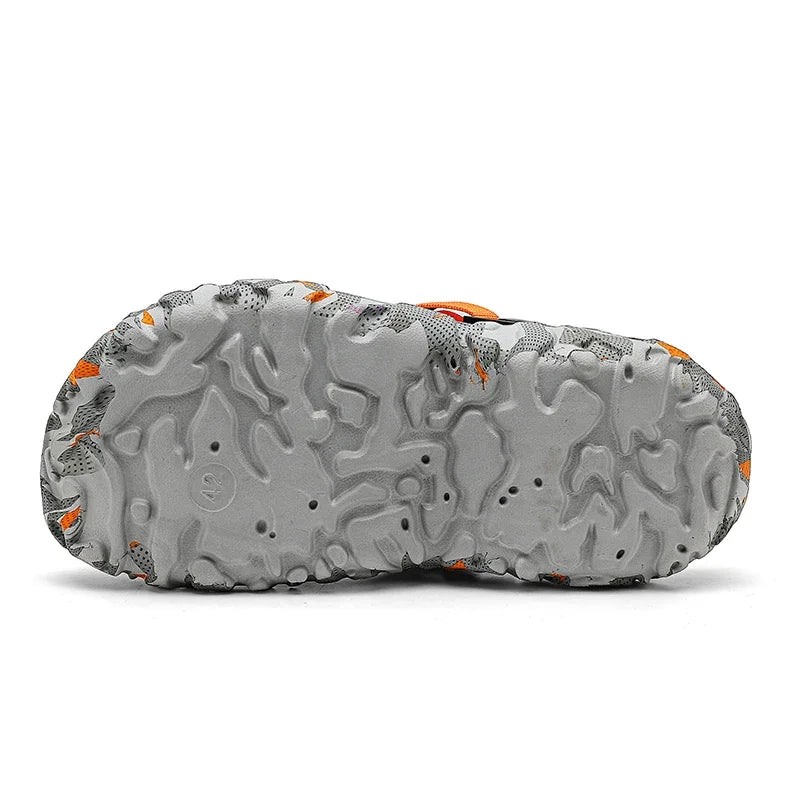 Camouflage garden clog outsole with textured tread and orange accents