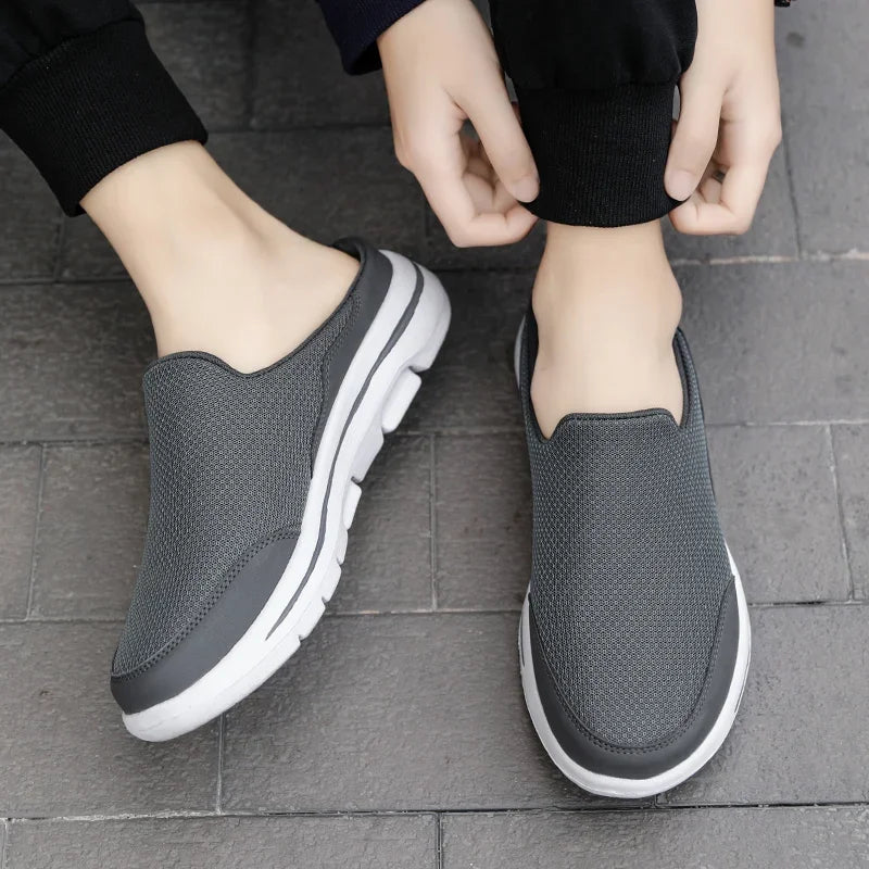 Gray backless slip-on slippers with white trim and cushioned thick sole