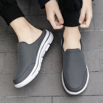 Gray backless slip-on slippers with white trim and cushioned thick sole