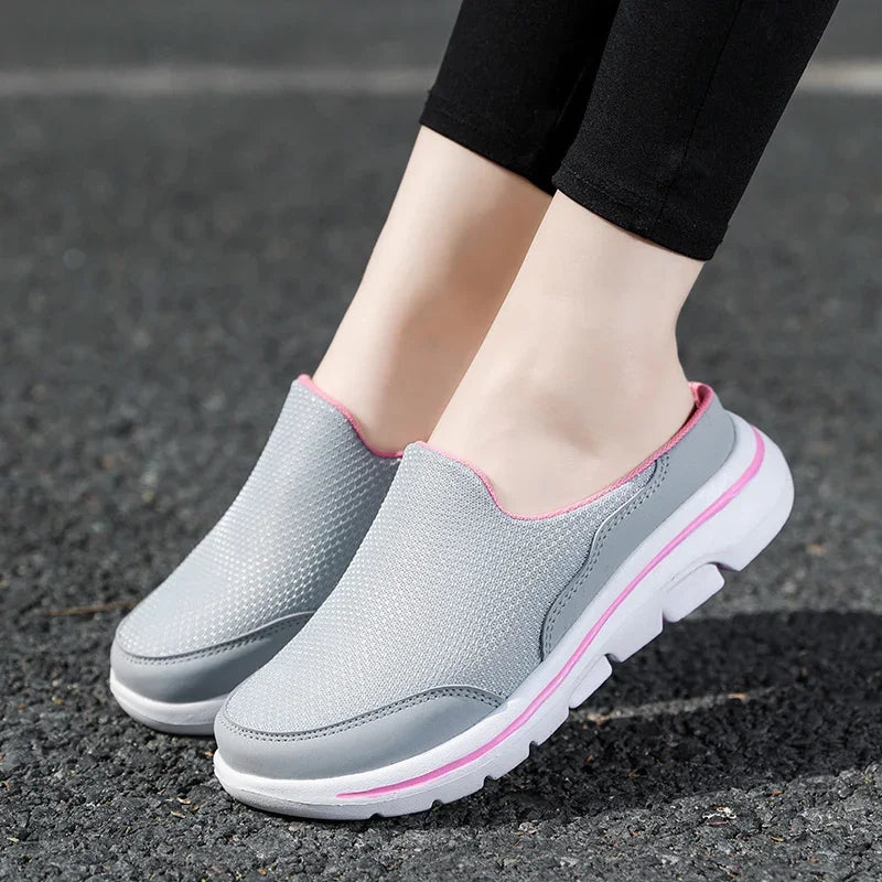 Light gray backless slippers with pink trim and thick white sole