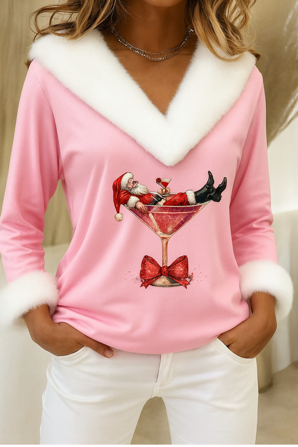 Pink plush V-neck festive sweater with white fur trim, long sleeves, cocktail graphic and bow