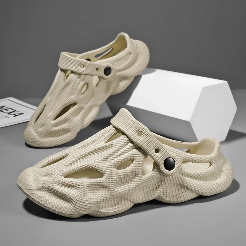Beige hollow garden clogs with oval cutouts and adjustable strap