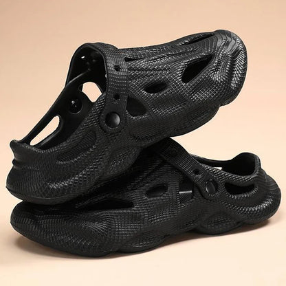 Black hollow garden clogs with textured finish and oval cutouts