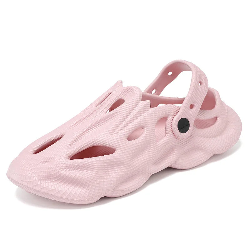 Pink slip-on clogs with hollow cutouts and ventilation holes