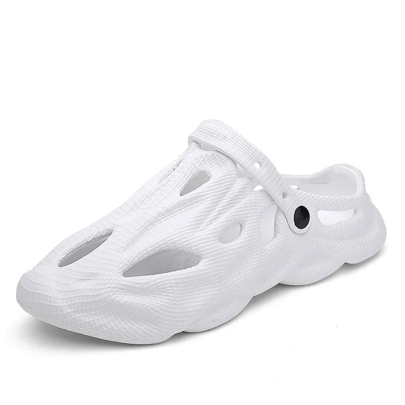 White hollow garden clogs with oval cutouts and buckle strap detail