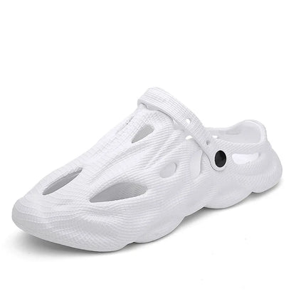 White hollow garden clogs with oval cutouts and buckle strap detail