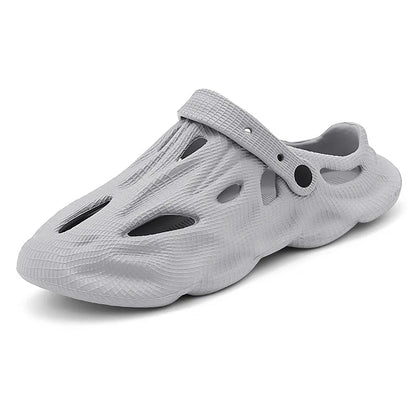 Light gray hollow garden clogs with oval cutouts and strap detail