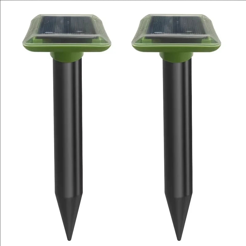 Solar ultrasonic mole repellent spike pair with black stakes and green solar panel tops
