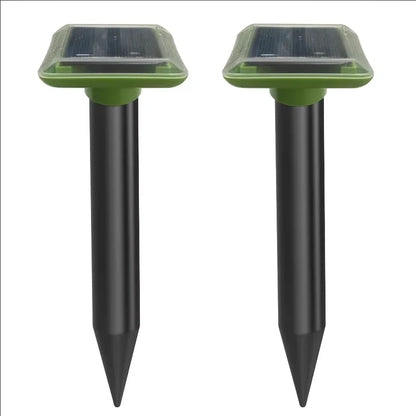 Solar ultrasonic mole repellent spike pair with black stakes and green solar panel tops