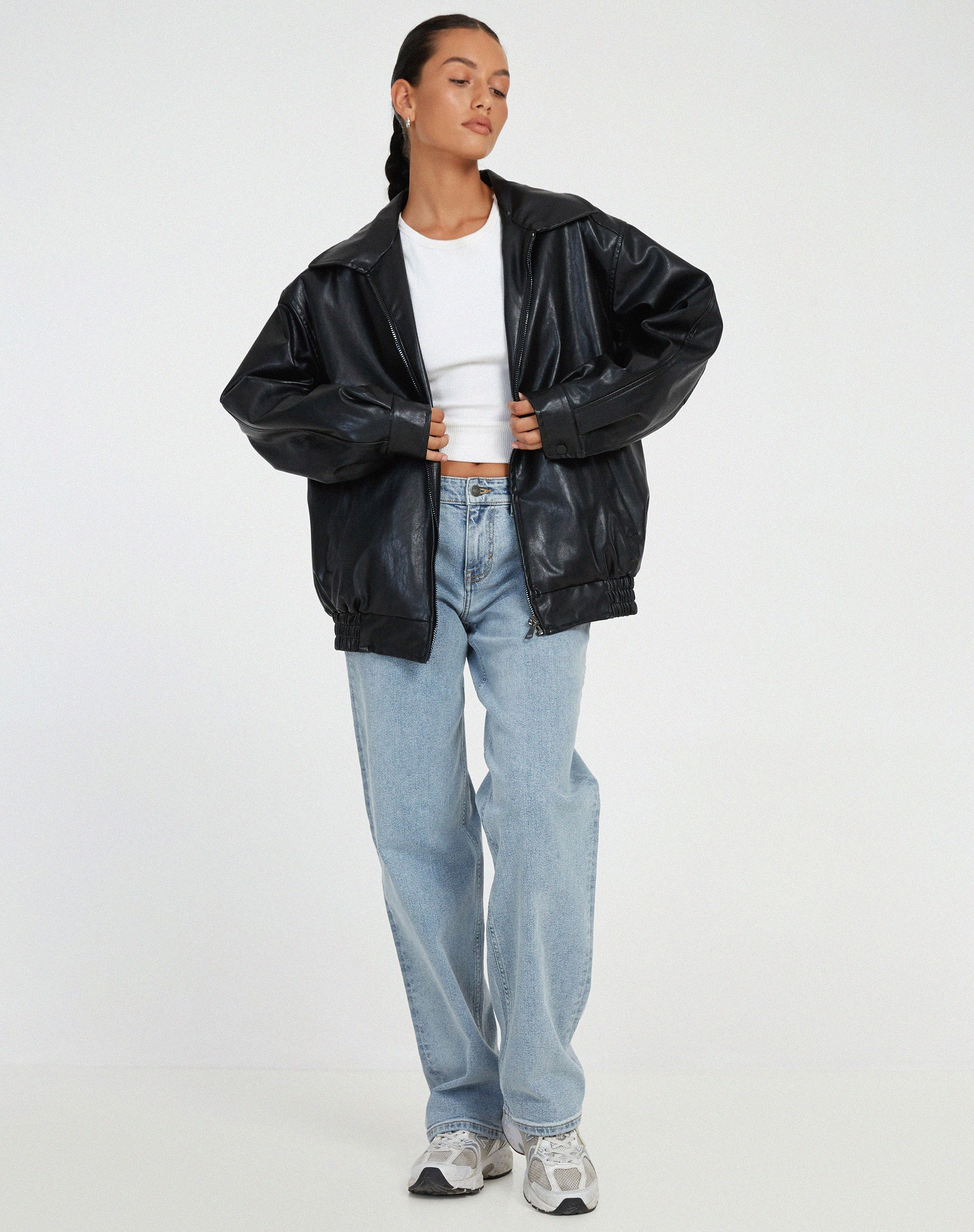 Black oversized PU leather jacket with zip front, stand collar, and elastic cuffs.