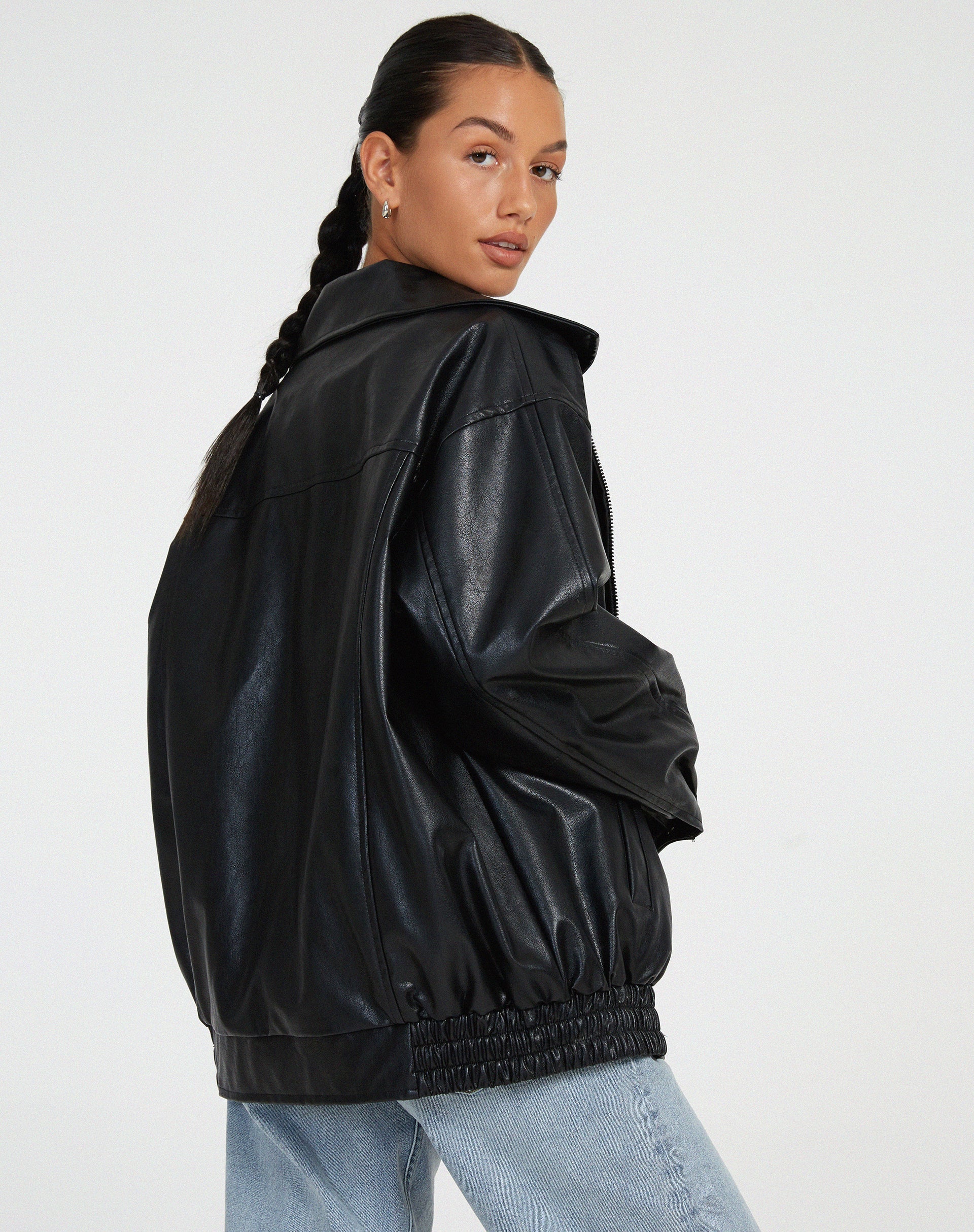 Black oversized PU leather bomber jacket with zip front and gathered elastic cuffs and hem.