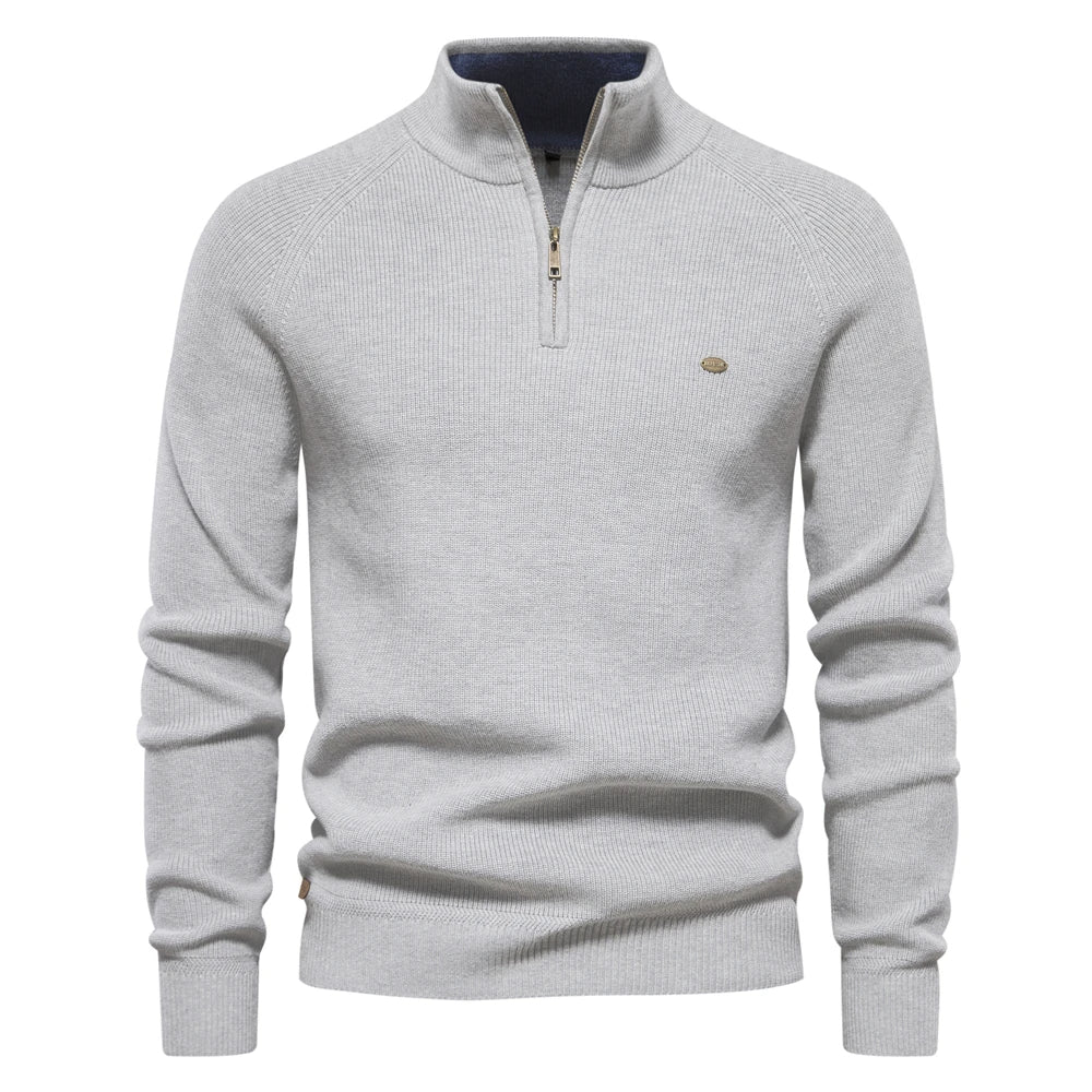 Ribbed half-zip knit sweater in light grey, long sleeves, stand collar, small chest logo.