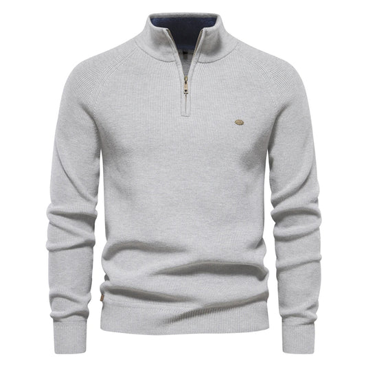 Ribbed half-zip knit sweater in light grey, long sleeves, stand collar, small chest logo.