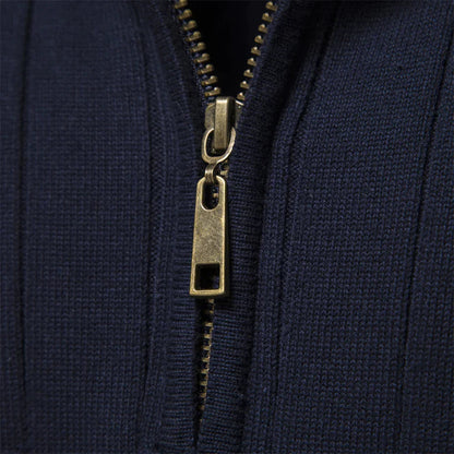 Close-up of navy half-zip knit sweater zipper with gold hardware.