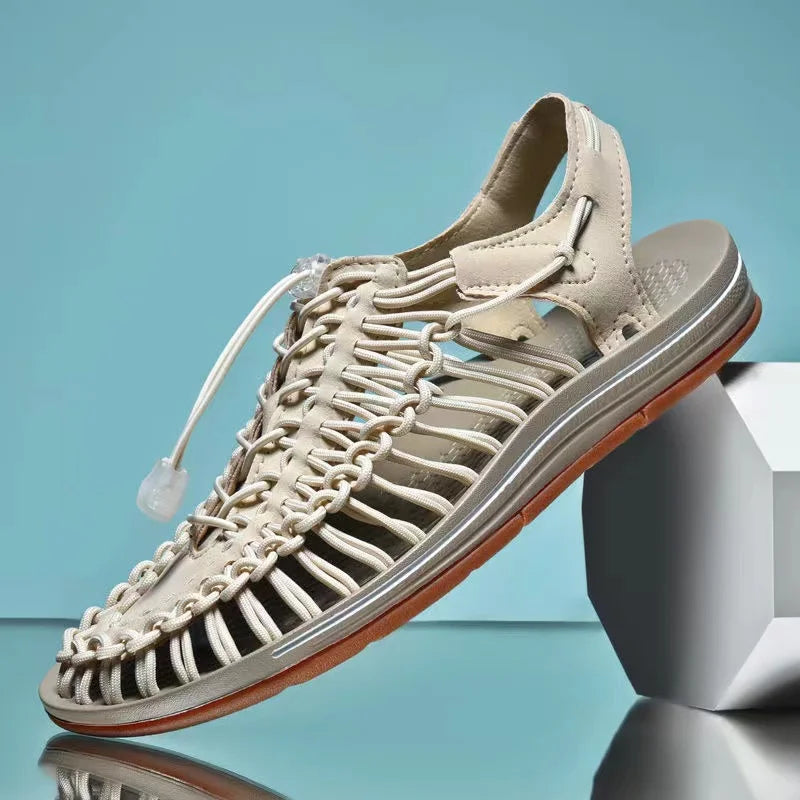 Cream woven water shoes with lace-up knit upper and light gray EVA sole.