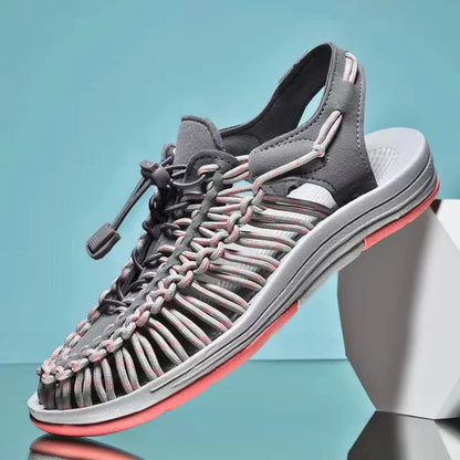 Gray woven water shoes with lace-up knit upper, multicolor threads, and gray EVA sole.