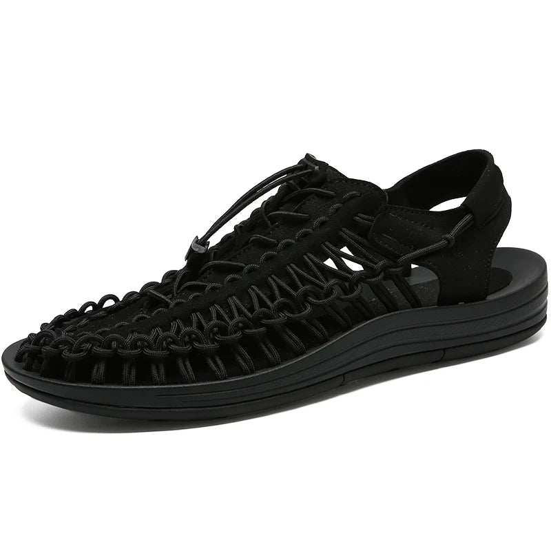 Black woven water shoes with lace-up knit upper and thick black EVA sole.