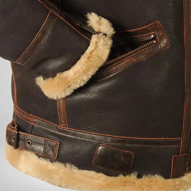 Men's shearling flight jacket detail of tan shearling cuff and front pocket with metal zipper