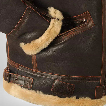 Men's shearling flight jacket detail of tan shearling cuff and front pocket with metal zipper