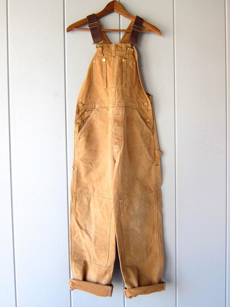 Men's camel canvas bib overalls with adjustable straps and front pockets