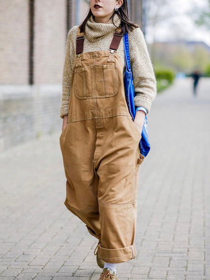 Men's camel canvas bib overalls with bib pocket, utility pockets, and wide legs