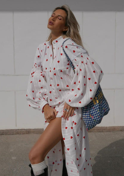 White heart-print maxi dress with long sleeves, button front, and relaxed fit