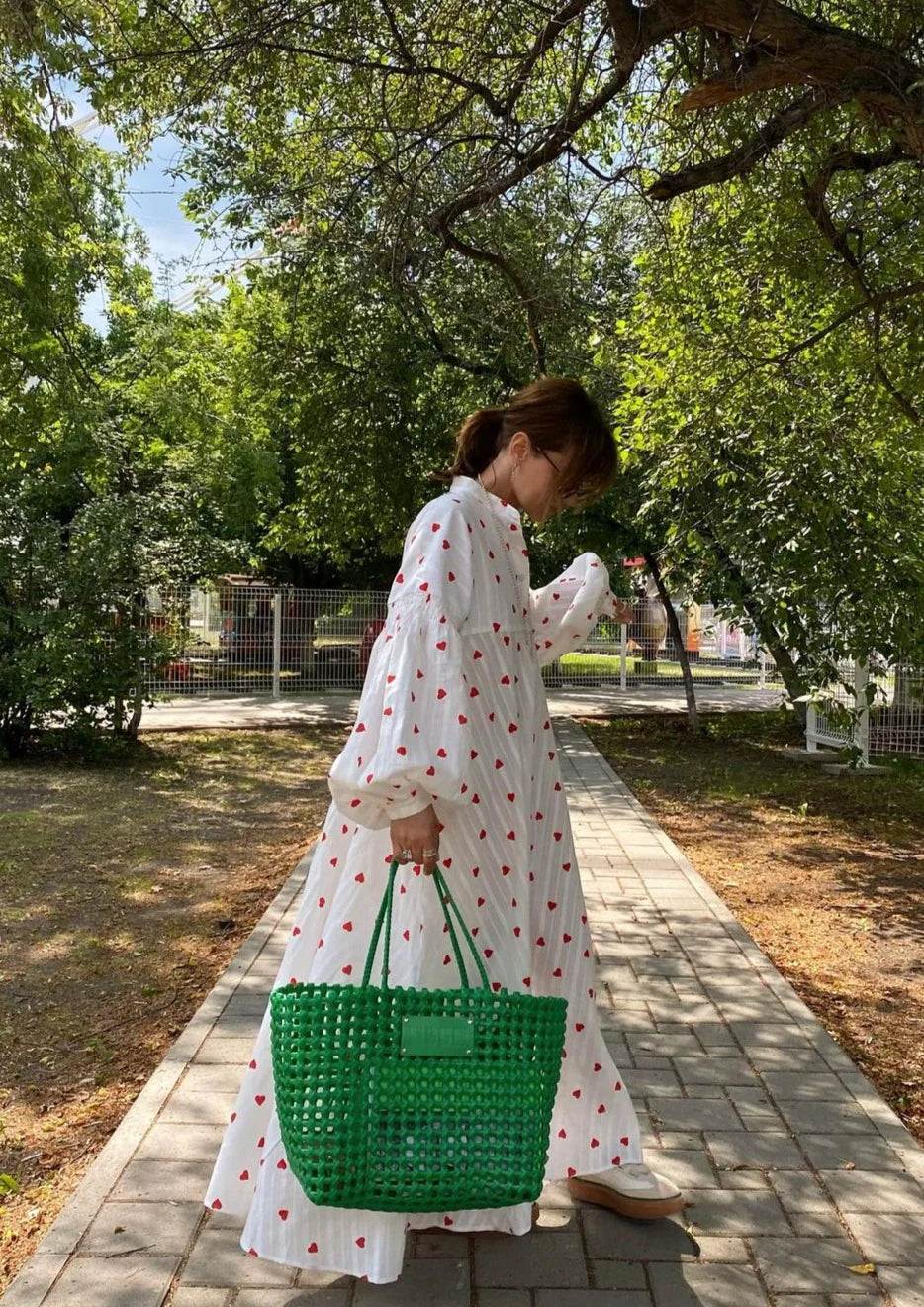 White maxi dress with red heart print, button front, long sleeves, gathered skirt