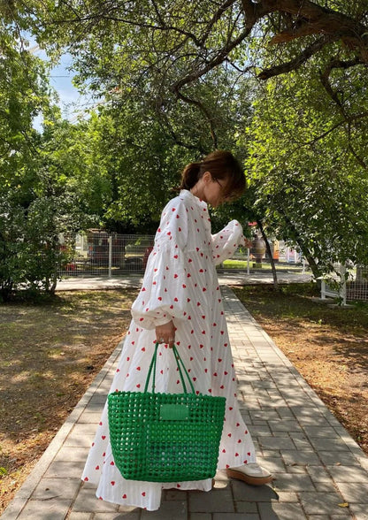 White maxi dress with red heart print, button front, long sleeves, gathered skirt