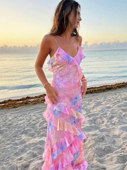 Ruffled tiered maxi dress with spaghetti straps, pastel floral print, beach side view