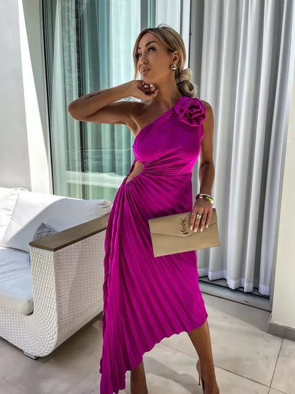 One-shoulder pleated maxi dress in fuchsia with rosette shoulder detail and pleated skirt