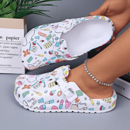 White medical-print nurse clogs, open mule with adjustable buckle strap.