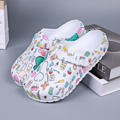 White medical-print nurse clog pair, open mule with adjustable buckle detail.