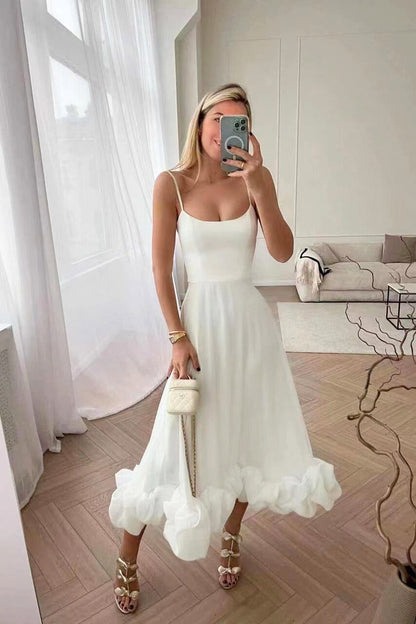 White midi dress with scoop neck and spaghetti straps, A-line skirt with ruffle hem