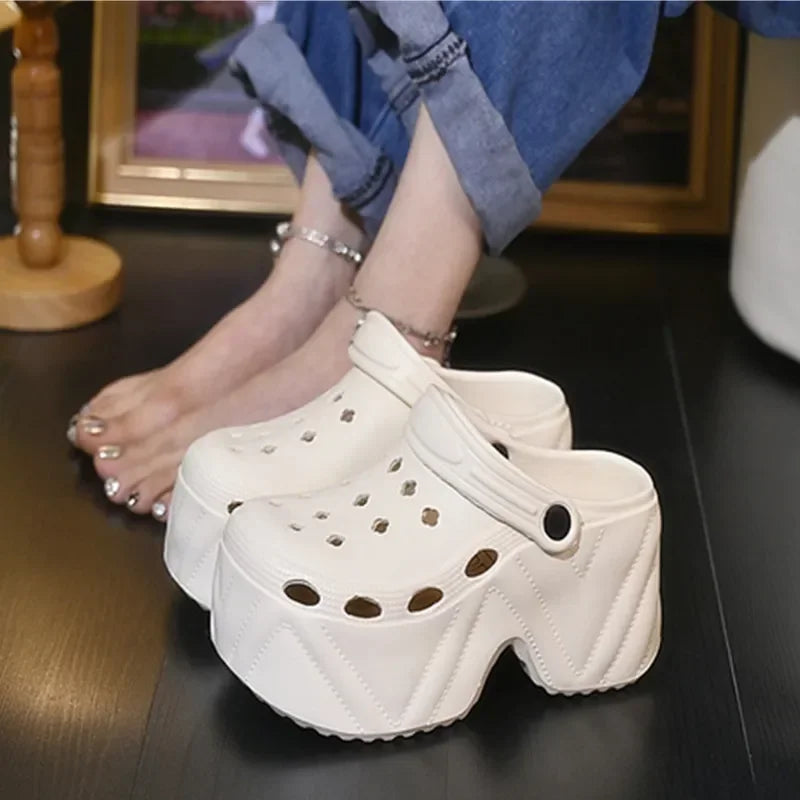 Women’s white platform clogs with decorative charm details and thick EVA sole