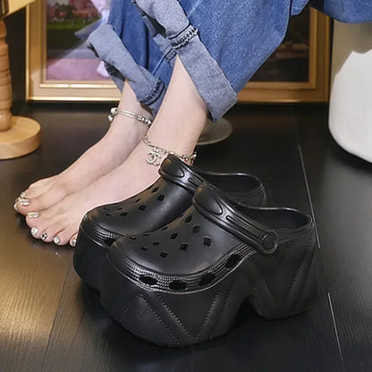 Women’s black platform clogs with perforations and decorative charm accents