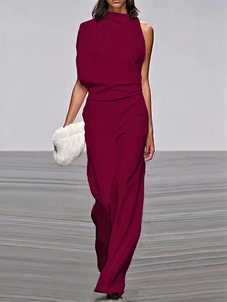 Deep red sleeveless high-neck wide-leg jumpsuit with draped waist and side cutouts