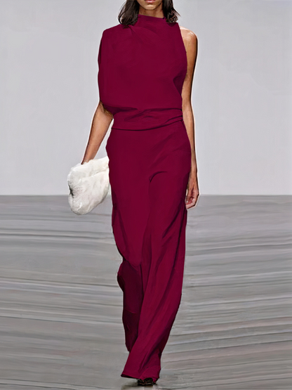 Deep red sleeveless high-neck wide-leg jumpsuit with draped waist and side cutouts