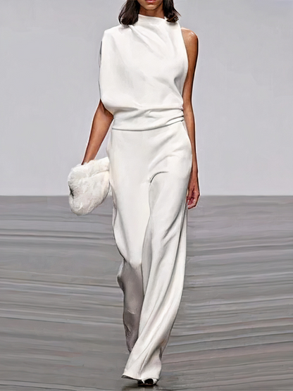 White sleeveless wide-leg jumpsuit with high neckline and fitted waist.