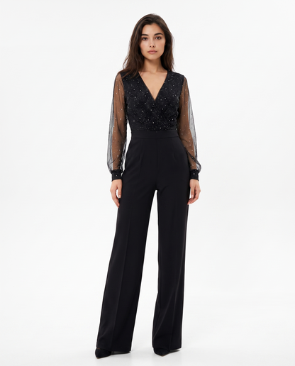Women's black jumpsuit with sheer dotted long sleeves and V-neck wrap bodice