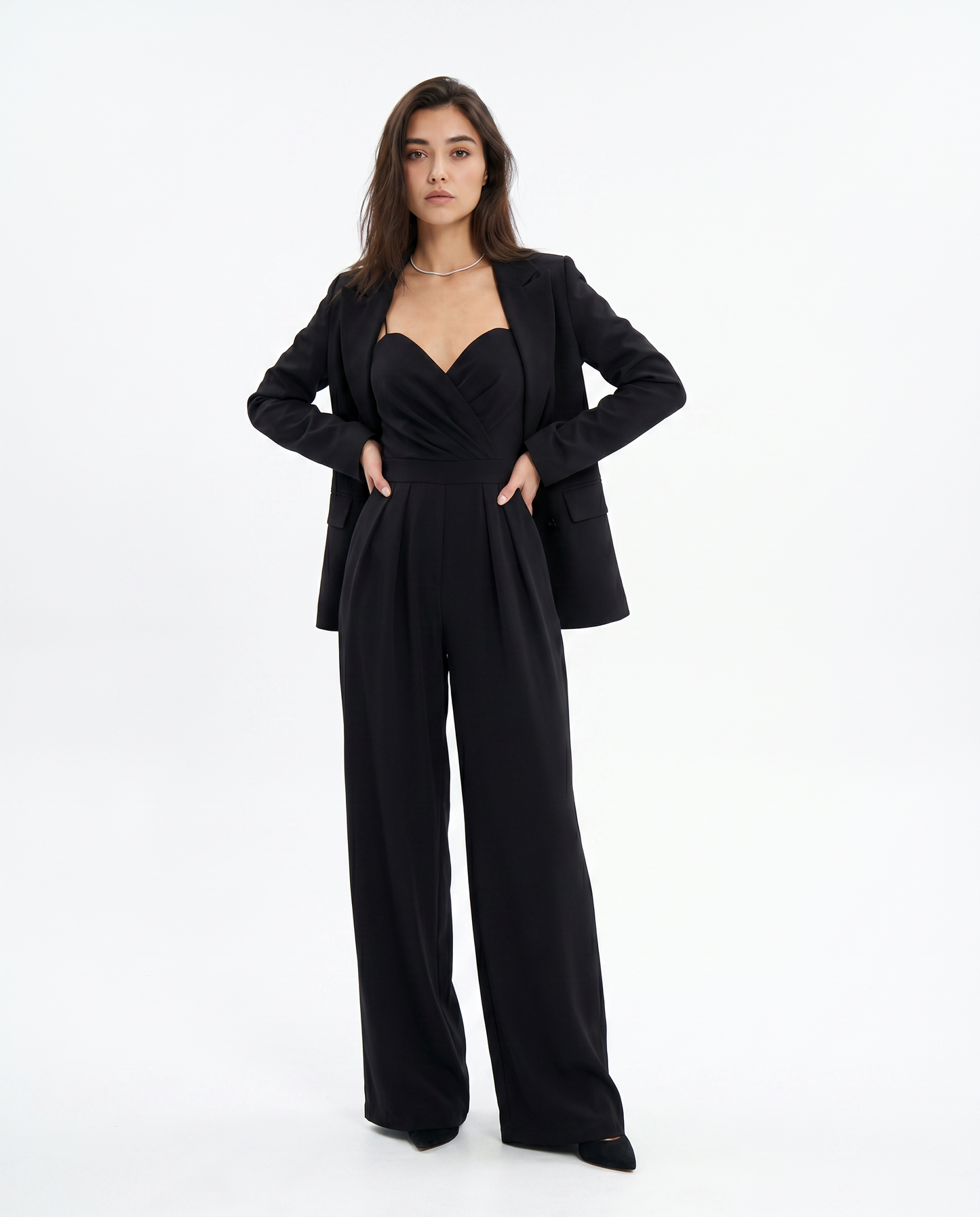 Black strappy wide-leg jumpsuit with sweetheart bust under a cropped blazer